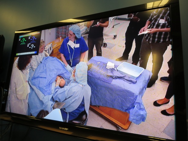 Watching a debrief of a birth simulation on CAPE's video monitor
